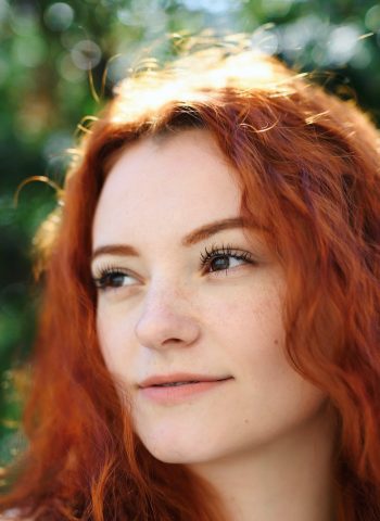 Close-up portrait of young woman outdoors in city, headshot